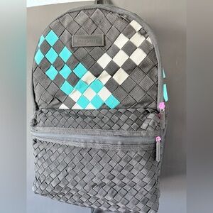 Sprayground South Beach Kumo Weave Deluxe backpack in grey, white, and teal.
